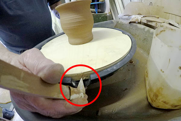 Device to fit to a potters wheel to centre clay